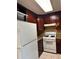 Bright kitchen featuring white appliances, ample cabinets, and tiled floors at 1807 Ashborough Se Cir # B, Marietta, GA 30067