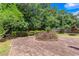 Large stone patio area surrounded by trees and well-maintained landscaping at 5414 Sweetsprings Sw Dr, Powder Springs, GA 30127