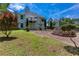 Two-story home featuring stone patio with lush backyard and second-story deck at 5414 Sweetsprings Sw Dr, Powder Springs, GA 30127