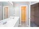 Bathroom with double vanity, walk-in closet, and neutral wall paint at 5414 Sweetsprings Sw Dr, Powder Springs, GA 30127