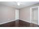 Bedroom with hardwood flooring, a light grey wall paint, and a door to another room at 5414 Sweetsprings Sw Dr, Powder Springs, GA 30127