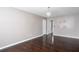 Bedroom featuring hardwood floors, light grey walls, and a doorway to another room at 5414 Sweetsprings Sw Dr, Powder Springs, GA 30127
