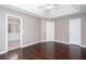Bedroom features tray ceilings, hardwood floors, neutral paint, and multiple doors at 5414 Sweetsprings Sw Dr, Powder Springs, GA 30127