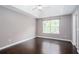 Spacious bedroom features hardwood floors, a large window, and a ceiling fan at 5414 Sweetsprings Sw Dr, Powder Springs, GA 30127
