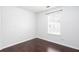 Bedroom with hardwood floors and a window offering natural light, creating a relaxing atmosphere at 5414 Sweetsprings Sw Dr, Powder Springs, GA 30127