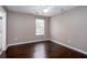 Bedroom with hardwood flooring, a light grey wall paint, a ceiling fan, and a window at 5414 Sweetsprings Sw Dr, Powder Springs, GA 30127