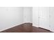 Clean and bright bedroom with two white doors and dark hardwood floors at 5414 Sweetsprings Sw Dr, Powder Springs, GA 30127