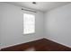 Bedroom featuring a window and hardwood floors, providing a comfortable space at 5414 Sweetsprings Sw Dr, Powder Springs, GA 30127