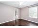 Bedroom featuring hardwood floors, light grey walls, and a doorway to an en-suite bathroom at 5414 Sweetsprings Sw Dr, Powder Springs, GA 30127