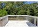 White deck overlooks a lush green backyard, perfect for relaxing and entertaining at 5414 Sweetsprings Sw Dr, Powder Springs, GA 30127