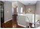 Elegant foyer boasts hardwood floors, a modern chandelier, and an arched entryway, creating a grand and inviting space at 5414 Sweetsprings Sw Dr, Powder Springs, GA 30127