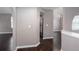 Inviting entryway with dark wood floors, neutral walls, arched doorways, and a glimpse of the stainless-steel refrigerator at 5414 Sweetsprings Sw Dr, Powder Springs, GA 30127