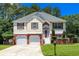Charming two-story home features a brick-and-stucco facade, complemented by a well-manicured lawn and a two-car garage at 5414 Sweetsprings Sw Dr, Powder Springs, GA 30127