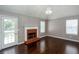 Living room featuring hardwood floors, a brick fireplace, and a modern chandelier at 5414 Sweetsprings Sw Dr, Powder Springs, GA 30127