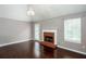 Spacious living room with a brick fireplace, hardwood floors, and a glass door at 5414 Sweetsprings Sw Dr, Powder Springs, GA 30127