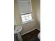 Powder room features pedestal sink, window, and neutral wall color scheme at 920 Society Sw Cir, Atlanta, GA 30331