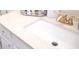 Close up on a bathroom vanity with a white countertop, sink, gold faucet and crystal knob hardware at 920 Society Sw Cir, Atlanta, GA 30331