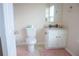 Cozy bathroom with a toilet, vanity and mirror with great natural lighting at 920 Society Sw Cir, Atlanta, GA 30331