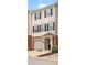 View of townhome featuring brick accents, attached garage, black shutters, and covered entry at 920 Society Sw Cir, Atlanta, GA 30331