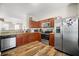 Open kitchen with stainless steel appliances, granite countertops, and wooden cabinetry at 920 Society Sw Cir, Atlanta, GA 30331