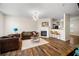 Open concept living room with hardwood floors, fireplace, and modern chandelier at 920 Society Sw Cir, Atlanta, GA 30331