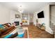 Bright living room featuring hardwood floors, fireplace, modern lighting, and neutral wall paint at 920 Society Sw Cir, Atlanta, GA 30331