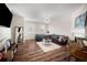 Cozy living room offering hardwood floors, fireplace, chic lighting, and natural light at 920 Society Sw Cir, Atlanta, GA 30331