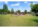 Outdoor playground with slides and climbing structures in green space next to neighborhood homes at 920 Society Sw Cir, Atlanta, GA 30331