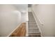 Well-lit stairway featuring carpeted steps, hardwood flooring, and a neutral color scheme at 920 Society Sw Cir, Atlanta, GA 30331