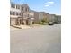 A lovely shot of the townhouse complex with garages and sidewalks on a sunny day at 920 Society Sw Cir, Atlanta, GA 30331