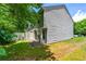 Side of the house with a small fenced-in area and mature trees providing shade at 1382 Hollenbeck Ln, Riverdale, GA 30296