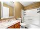 Bathroom with a wooden sink base and shower-tub combination at 1382 Hollenbeck Ln, Riverdale, GA 30296