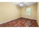 Cozy bedroom featuring hardwood flooring, a ceiling fan, and a bright window at 1382 Hollenbeck Ln, Riverdale, GA 30296
