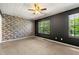 Bedroom with stone accent wall and plenty of natural light from the large window at 1382 Hollenbeck Ln, Riverdale, GA 30296