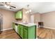 Bright kitchen featuring granite countertops, stainless steel appliances, and green cabinets at 1382 Hollenbeck Ln, Riverdale, GA 30296