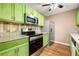 Modern kitchen featuring stainless steel appliances, granite countertops, and green cabinets at 1382 Hollenbeck Ln, Riverdale, GA 30296