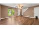 Bright living room featuring hardwood floors, a ceiling fan, and natural light from a large window at 1382 Hollenbeck Ln, Riverdale, GA 30296