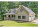 Charming two-story home with a welcoming porch, attached garage, and beautiful landscaping at 1580 Lower Burris Rd, Canton, GA 30114