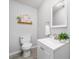 Clean half bath with grey walls, stylish fixtures, and a framed print above the toilet at 1580 Lower Burris Rd, Canton, GA 30114