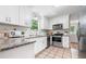 Well-lit kitchen with white cabinets, stainless steel appliances, and granite countertops at 1580 Lower Burris Rd, Canton, GA 30114