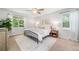 Serene main bedroom featuring a large window, ceiling fan, and neutral décor at 1580 Lower Burris Rd, Canton, GA 30114