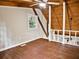 Open attic space featuring wood floors, wood-beamed ceiling with fan and railing, with natural light from the window at 5642 Dorsett Shoals Rd, Douglasville, GA 30135