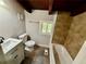 Cozy bathroom features a modern vanity, toilet, and tiled shower/tub combo, complemented by a window for natural light at 5642 Dorsett Shoals Rd, Douglasville, GA 30135