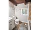 Bathroom featuring wood ceiling beams, updated vanity and tile flooring at 5642 Dorsett Shoals Rd, Douglasville, GA 30135