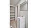 Bathroom with vanity, mirror, tile floors and doorway to additional storage and room at 5642 Dorsett Shoals Rd, Douglasville, GA 30135