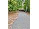 Gravel driveway leading to a cozy log cabin nestled among the trees at 5642 Dorsett Shoals Rd, Douglasville, GA 30135