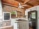 Cozy kitchen with brick accents, stainless steel appliances, and an island at 5642 Dorsett Shoals Rd, Douglasville, GA 30135