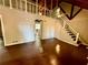 Open living area with hardwood floors, a staircase, and a loft above at 5642 Dorsett Shoals Rd, Douglasville, GA 30135