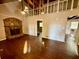 Spacious living room with hardwood floors, stone fireplace, and vaulted ceilings at 5642 Dorsett Shoals Rd, Douglasville, GA 30135