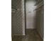 Walk-in closet featuring vintage wallpaper and shelving, offering ample storage or renovation opportunities at 809 Camelot Dr # 809, College Park, GA 30349
